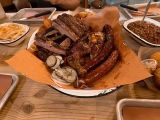 Photo of a platter of barbecue on a wood table