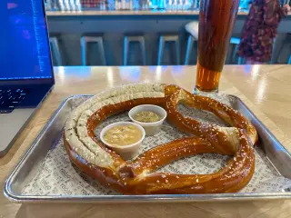 Photo of a large pretzel and a beer