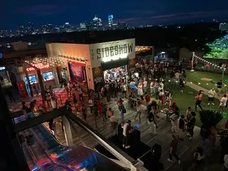 Photo of a crowd of people on a rooftop in Atlanta