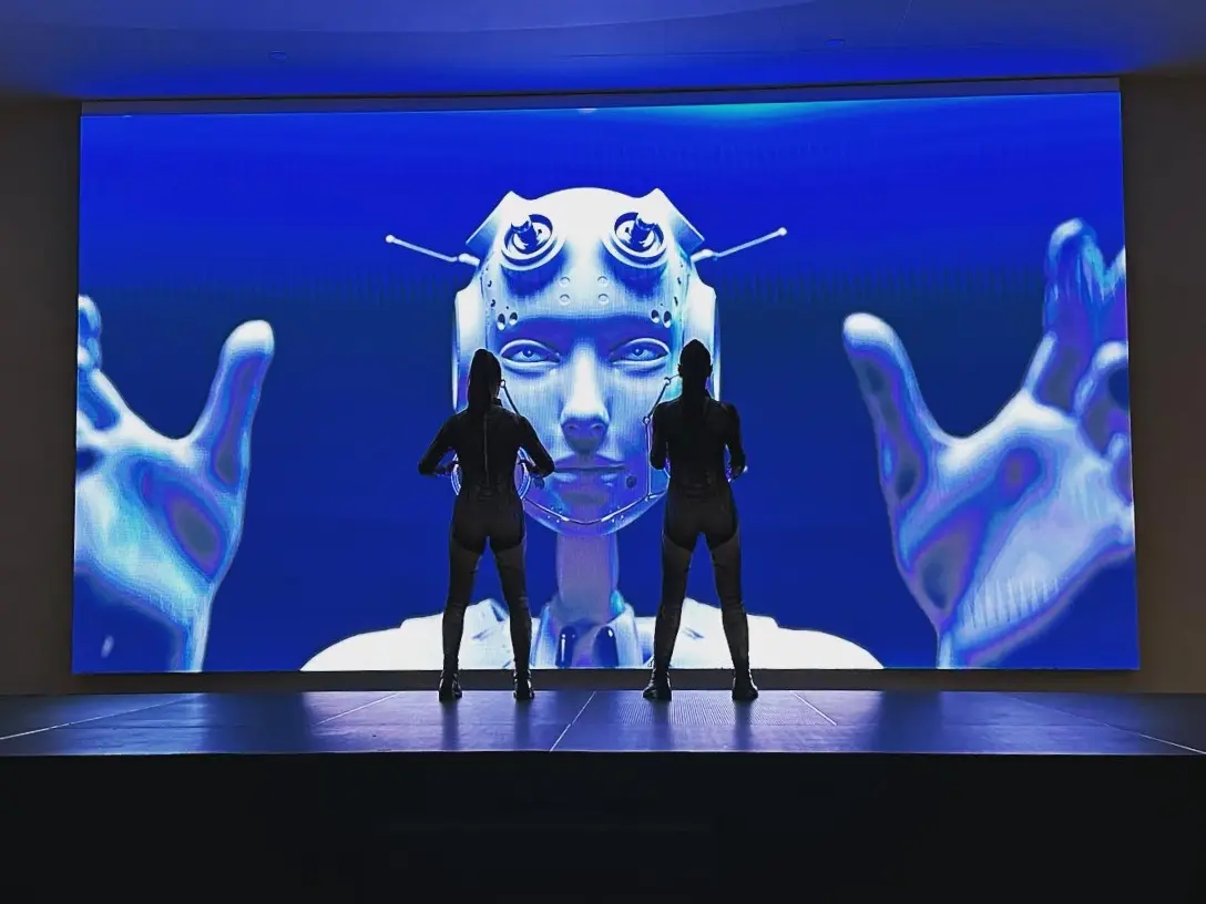 Photo of two dancers and a futuristic background